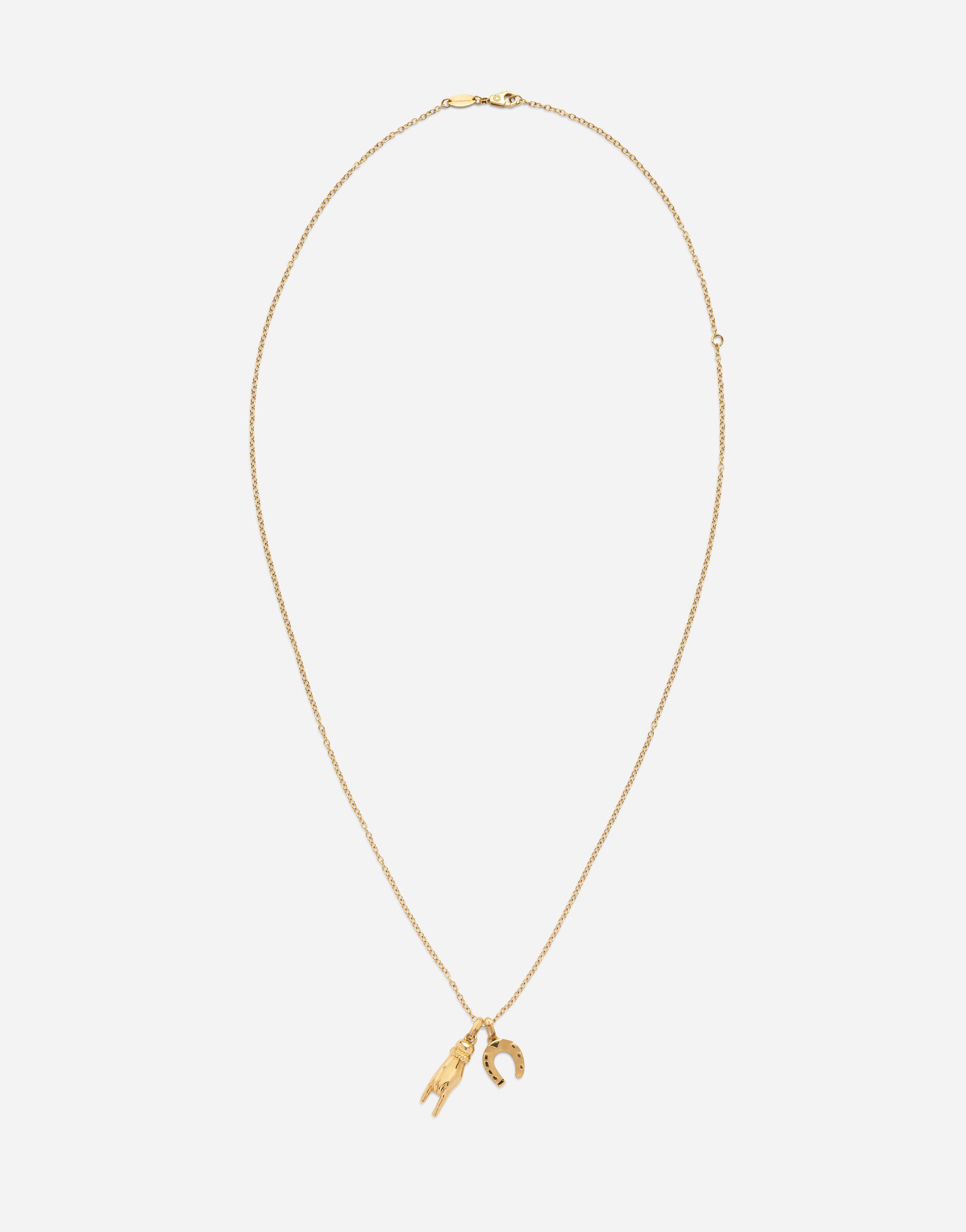 Good luck hand with horn and horseshoe pendants on yellow gold chain in Gold
